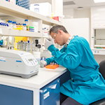 Researcher in a laboratory extracting a sample