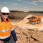 Miner with truck in background