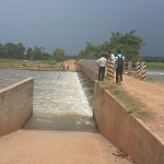 Reseacher examining a weir