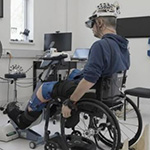 A wheelchair-bounded participant attending the BioSpine laboratory
