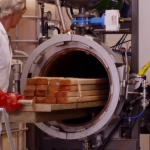 Timber being rolled into a wood kiln