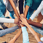 Overhead view of a cricle of joined hands