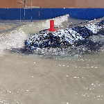 Wave flume assessment of rock seawall stability under wave attack.