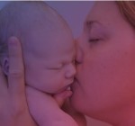 Mother kissing a baby