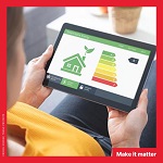 A woman looking at an energy class graphic and a green house