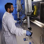 Scientist operating a hot cell