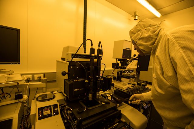 A man in a lab coat conducting experiments in a laboratory.